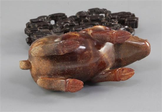 A Chinese archaistic white and brown jade figure of a standing pig, 9.6cm, with carved wood stand and fitted box